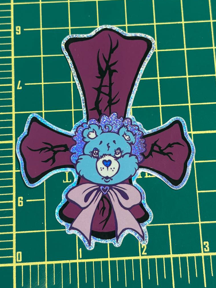 Patch of a blue bear with purple bows on a green cutting mat