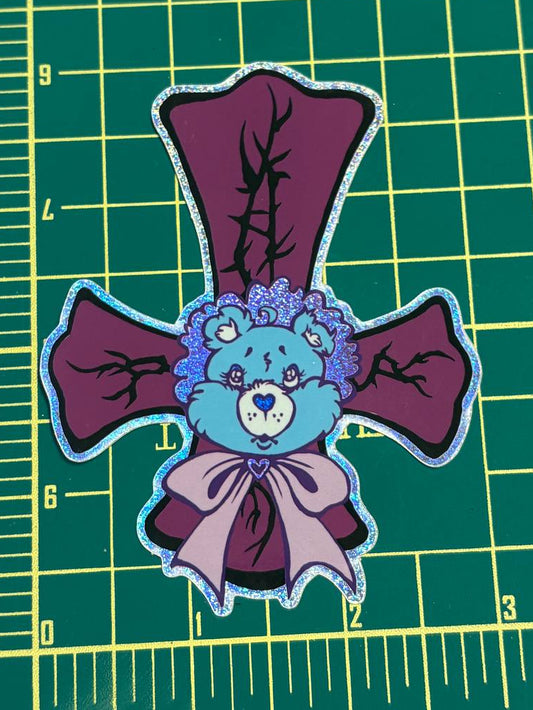 Patch of a blue bear with purple bows on a green cutting mat